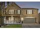 Charming two-story brick home with attached garage, covered porch, and manicured front lawn at 8327 Andrusia Ln, Indianapolis, IN 46237
