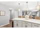 Kitchen island featuring quartz countertop, pendant lights, and seating at 8327 Andrusia Ln, Indianapolis, IN 46237