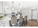 Open-concept kitchen with breakfast bar, pendant lighting, and modern appliances at 8327 Andrusia Ln, Indianapolis, IN 46237
