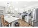 Bright kitchen featuring white cabinetry, stainless steel appliances, and elegant pendant lighting at 8327 Andrusia Ln, Indianapolis, IN 46237