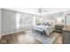 Bright main bedroom features large windows, plush bedding, and stylish decor at 8327 Andrusia Ln, Indianapolis, IN 46237