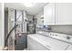 Functional utility room equipped with laundry machines, storage cabinets, and essential utilities at 8327 Andrusia Ln, Indianapolis, IN 46237