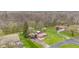 Aerial view of a wooded residential area with a mix of homes and mature trees at 874 S Sycamore Dr, Greenfield, IN 46140