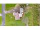 Aerial view showcasing home with metal roof, and large detached structure. Fire pit in yard at 874 S Sycamore Dr, Greenfield, IN 46140