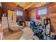 Finished attic featuring wood walls, windows, boxes, and a blue gaming chair, offering a flexible, unique space at 874 S Sycamore Dr, Greenfield, IN 46140