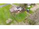 Aerial view of a large backyard with a fire pit, shed, and an orange tractor at 874 S Sycamore Dr, Greenfield, IN 46140
