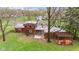 Aerial view of a backyard with a patio, wood pile, and a large tree at 874 S Sycamore Dr, Greenfield, IN 46140