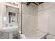 Compact bathroom with a pedestal sink, bathtub, and natural light at 874 S Sycamore Dr, Greenfield, IN 46140