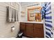 Cozy bathroom with wood vanity, framed mirror, and shiplap walls, offering a comfortable and rustic feel at 874 S Sycamore Dr, Greenfield, IN 46140