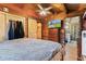 The spacious bedroom showcases a TV, closet with sliding barn door, and bathroom access, complete with wood paneled walls at 874 S Sycamore Dr, Greenfield, IN 46140