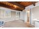 Bright bedroom with beamed ceiling, neutral walls, and two windows overlooking the trees at 874 S Sycamore Dr, Greenfield, IN 46140