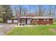 Charming one-story home with well-maintained lawn and landscaping, with attached garage and inviting porch at 874 S Sycamore Dr, Greenfield, IN 46140