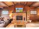 Cozy living room featuring a brick fireplace with a mounted TV above it at 874 S Sycamore Dr, Greenfield, IN 46140