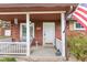 Inviting front porch with detailed decor and a 'Home Sweet Home' welcome sign, creating a warm ambiance at 874 S Sycamore Dr, Greenfield, IN 46140