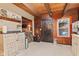 The kitchen showcases wood paneling, painted cabinets and views to dining area at 874 S Sycamore Dr, Greenfield, IN 46140