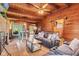 Open-concept living room with wood paneling, exposed beams, and a cozy seating area at 874 S Sycamore Dr, Greenfield, IN 46140