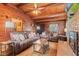Comfortable living room with wood walls, a brick fireplace, and cozy brown couches at 874 S Sycamore Dr, Greenfield, IN 46140