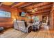 Inviting living room with wood paneled walls, brick fireplace, and comfortable seating at 874 S Sycamore Dr, Greenfield, IN 46140