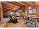 Inviting space with a fireplace, comfortable seating, a dining table, and wood paneling at 874 S Sycamore Dr, Greenfield, IN 46140