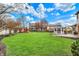 Large, landscaped backyard with gazebo and play equipment, perfect for Gathering enjoyment and outdoor activities at 9319 Oak Knoll Ln, Fishers, IN 46037