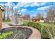 Landscaped backyard featuring a gazebo, brick pathway, flowering trees, and play equipment, creating an inviting outdoor space at 9319 Oak Knoll Ln, Fishers, IN 46037