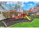 Backyard with a well-maintained lawn and play area with a swing set and slide, perfect for outdoor activities at 9319 Oak Knoll Ln, Fishers, IN 46037