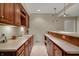 Finished basement wet bar with custom cabinetry and a built-in beverage refrigerator at 9319 Oak Knoll Ln, Fishers, IN 46037