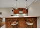 Finished basement wet bar features custom cabinetry, bar stool seating and recessed lighting at 9319 Oak Knoll Ln, Fishers, IN 46037