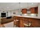 Finished basement wet bar features custom cabinetry, bar stool seating and recessed lighting at 9319 Oak Knoll Ln, Fishers, IN 46037