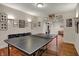Basement recreation room featuring ping pong table and gallery wall, perfect for entertaining at 9319 Oak Knoll Ln, Fishers, IN 46037