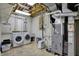 Laundry area with front load washer and dryer, utility sink, and HVAC system at 9319 Oak Knoll Ln, Fishers, IN 46037
