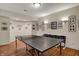 Finished basement featuring a ping pong table and decorated walls, creating a rec space at 9319 Oak Knoll Ln, Fishers, IN 46037