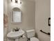 A half bath with a pedestal sink and white toilet at 9319 Oak Knoll Ln, Fishers, IN 46037