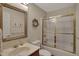 Bathroom features a large framed mirror over the sink and glass shower doors at 9319 Oak Knoll Ln, Fishers, IN 46037