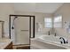 Bathroom featuring a walk-in shower and a soaking tub, perfect for unwinding after a long day at 9319 Oak Knoll Ln, Fishers, IN 46037