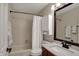 Bathroom with a shower-tub combo, vanity, and white storage cabinet over the toilet at 9319 Oak Knoll Ln, Fishers, IN 46037