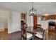 A dining area features a dark wood table with chairs and a decorative chandelier at 9319 Oak Knoll Ln, Fishers, IN 46037