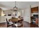 Dining area showcasing a wood table, modern lighting, and an open view to the living room at 9319 Oak Knoll Ln, Fishers, IN 46037