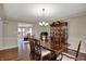 The dining room features hardwood floors, a china cabinet and flows into the living room at 9319 Oak Knoll Ln, Fishers, IN 46037
