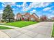 Lovely brick home with a spacious lawn, paved driveway, and mature landscaping at 9319 Oak Knoll Ln, Fishers, IN 46037
