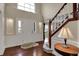 Bright foyer with hardwood floors, elegant staircase, and a large arched window at 9319 Oak Knoll Ln, Fishers, IN 46037