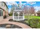 Detailed view of gazebo featuring outdoor furniture, surrounded by beautiful landscaping and brick pathway at 9319 Oak Knoll Ln, Fishers, IN 46037