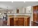 Well-lit kitchen featuring wood cabinets, granite counters, and open floor plan at 9319 Oak Knoll Ln, Fishers, IN 46037
