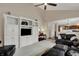 A spacious living room features a fireplace and built-in shelving with views to the kitchen at 9319 Oak Knoll Ln, Fishers, IN 46037
