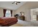 Spacious main bedroom featuring neutral walls, plush carpet, and a ceiling fan for added comfort at 9319 Oak Knoll Ln, Fishers, IN 46037