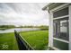 Beautiful backyard with a screened-in porch, green lawn, and a serene view of the lake at 9455 Orchard Cove Dr, Indianapolis, IN 46239