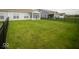 Spacious backyard featuring a well-manicured lawn and black fence at 9455 Orchard Cove Dr, Indianapolis, IN 46239