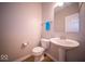 Comfortable half bath featuring tile floors, modern sink, and well-lit mirror at 9455 Orchard Cove Dr, Indianapolis, IN 46239