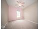 Bright bedroom with neutral carpet, soft pink accent wall, and a ceiling fan at 9455 Orchard Cove Dr, Indianapolis, IN 46239