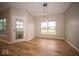 Bright dining room with hardwood floors, large windows, and a view of the lake at 9455 Orchard Cove Dr, Indianapolis, IN 46239